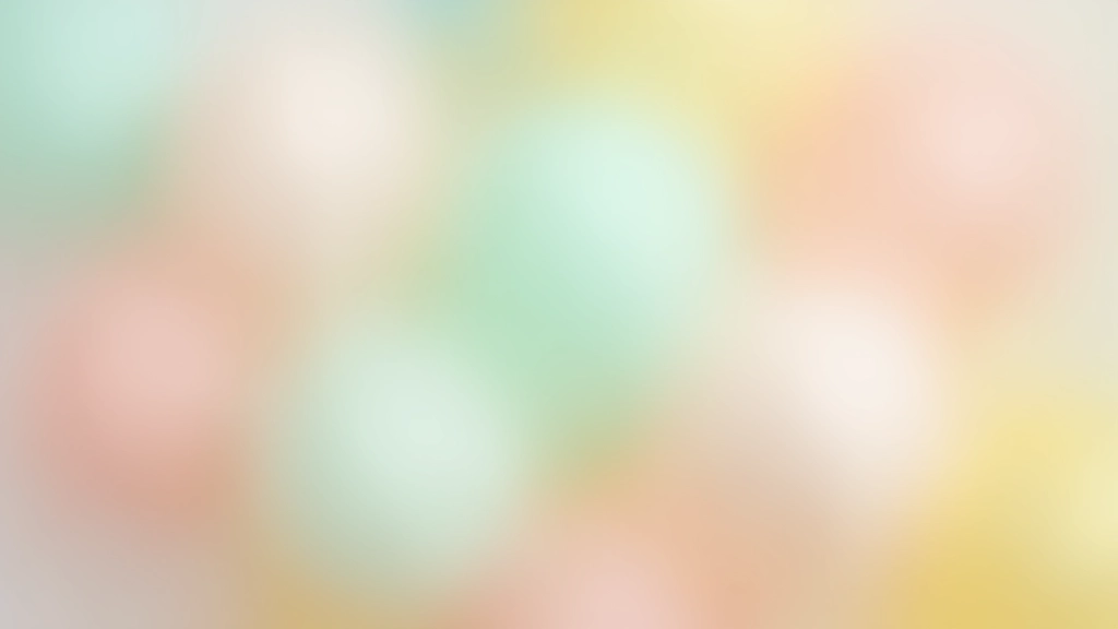Close-up view of pastel balloon color combinations arranged together, showing soft pink, mint green, and pale yellow tones in natural lighting